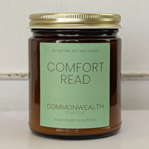 Candle with a green label on a white surface