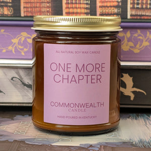 Candle jar with 'One More Chapter' label on a bookshelf background